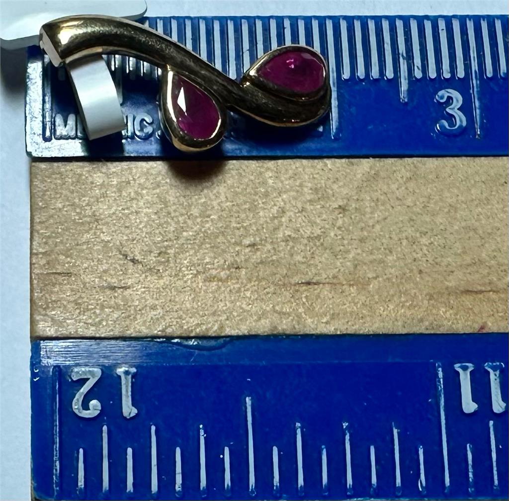 9ct yellow gold ruby pendant weighing 1.2g, featuring a vibrant ruby gemstone in a simple gold setting.