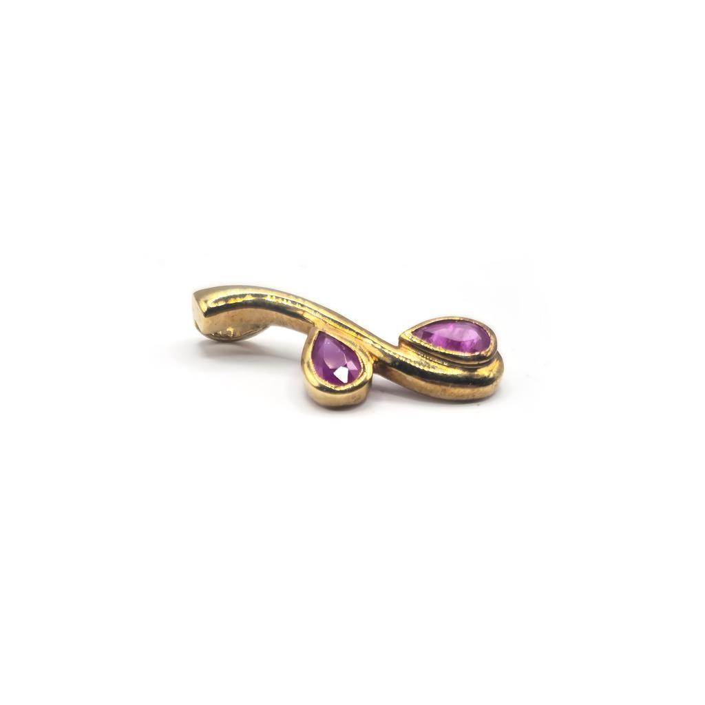 9ct yellow gold ruby pendant showing a vibrant red ruby gemstone set in a delicate gold setting.