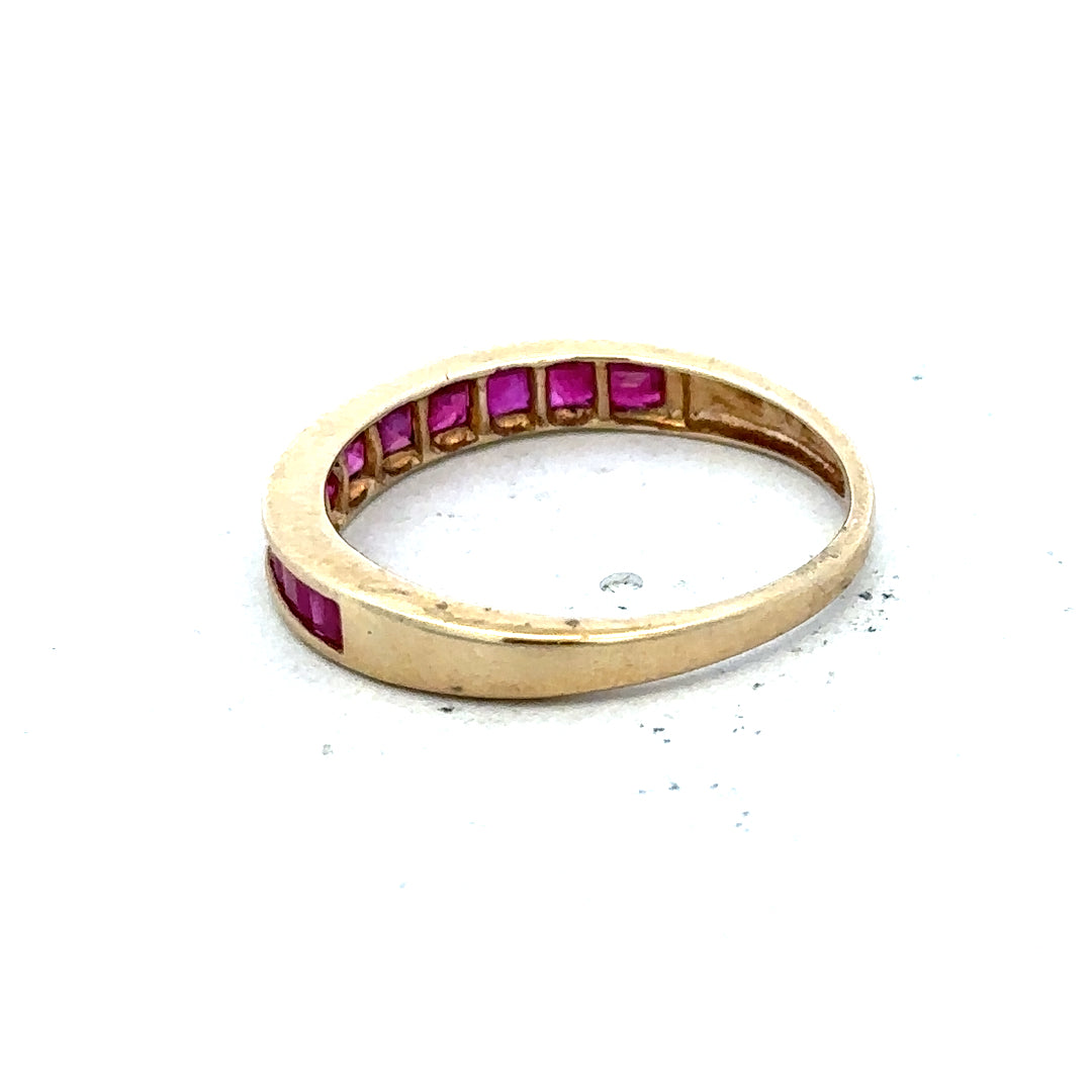 9ct yellow gold ruby ring in size P1/2 featuring a vibrant central ruby gemstone and a polished gold band.