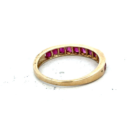 9ct yellow gold ruby ring size P1/2 with a central red ruby gemstone, natural gold band, on a white background.
