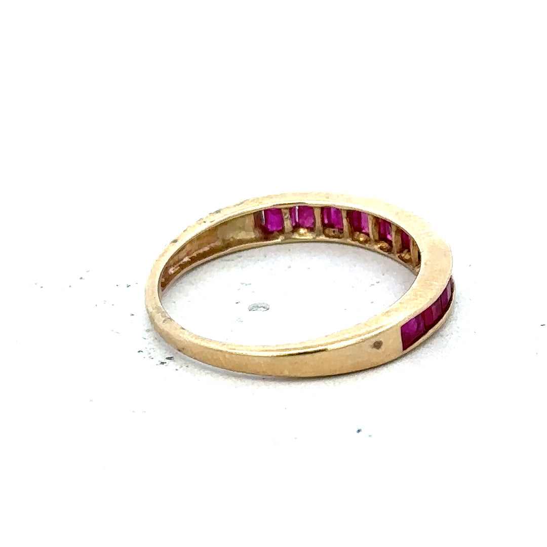 9ct yellow gold ruby ring in size P1/2, featuring a central red ruby gemstone and a polished gold band.