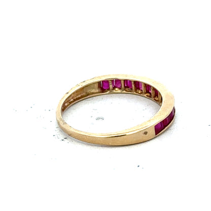 9ct yellow gold ruby ring in size P1/2, featuring a central red ruby gemstone and a polished gold band.