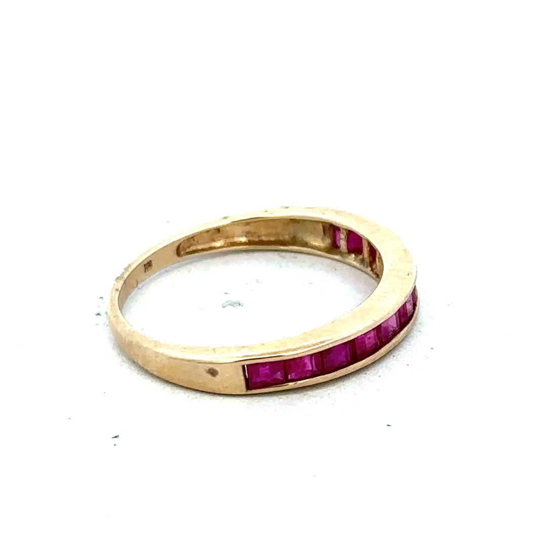 9ct yellow gold ruby ring in size P1/2 with a central ruby gemstone and a polished gold band