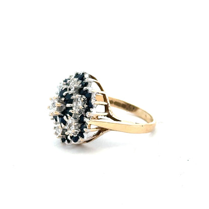 9ct yellow gold sapphire and diamond ring in size K, featuring a central sapphire surrounded by diamonds.