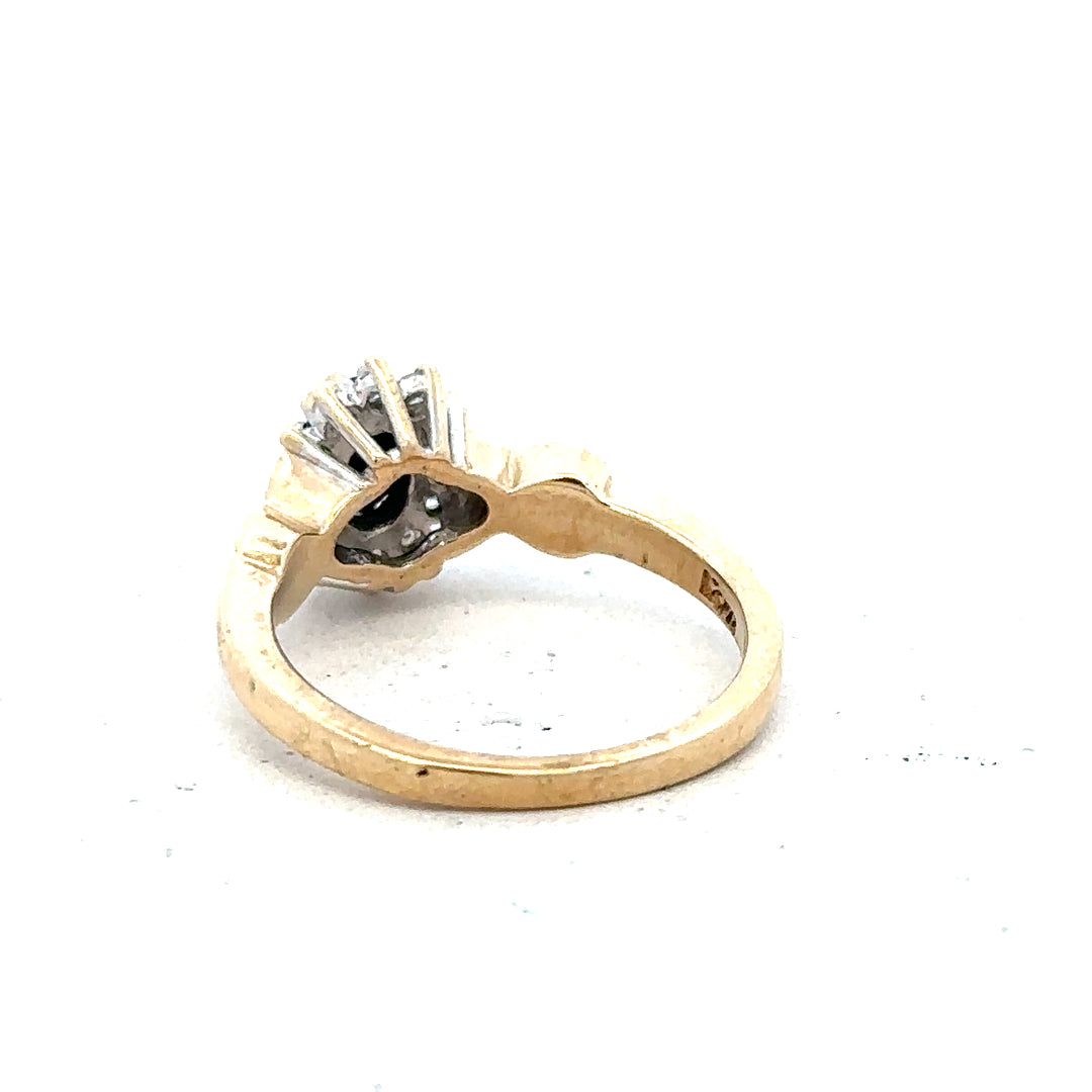 9ct yellow gold sapphire and diamond ring, size K1/2, showcasing a central sapphire surrounded by sparkling diamonds.