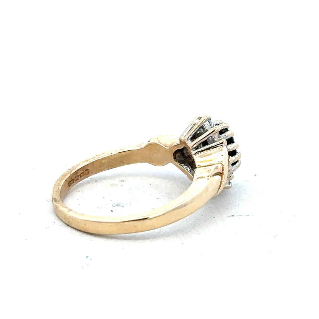 9ct yellow gold sapphire and diamond ring in size K1/2, featuring a central sapphire with diamond accents.