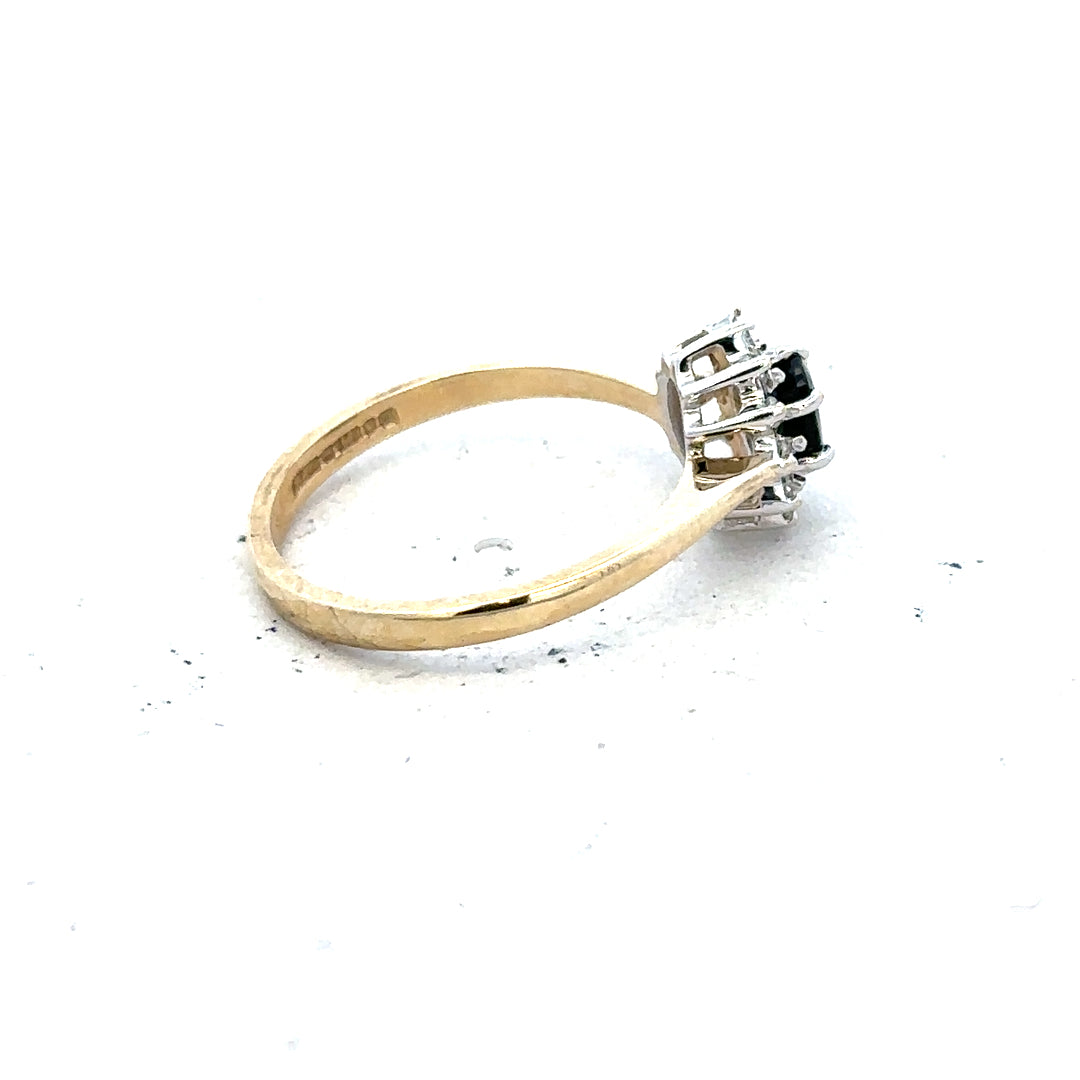 9ct yellow gold sapphire and diamond ring in size L, featuring a central sapphire with diamond accents on a sleek band.
