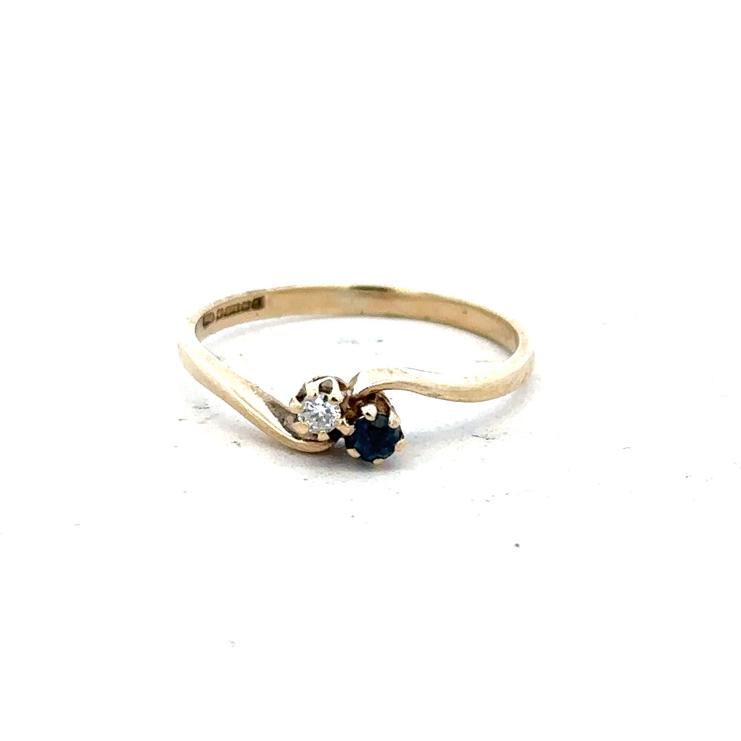 9ct yellow gold sapphire and diamond ring in size M, featuring a polished band with a central sapphire and diamond accents.