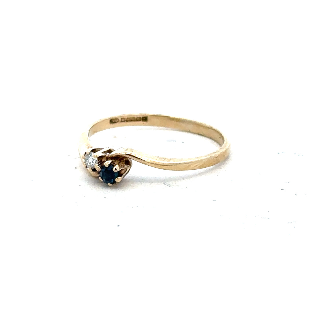 9ct yellow gold sapphire and diamond ring in size M, showcasing a detailed design with vibrant blue sapphire and sparkling diamonds.
