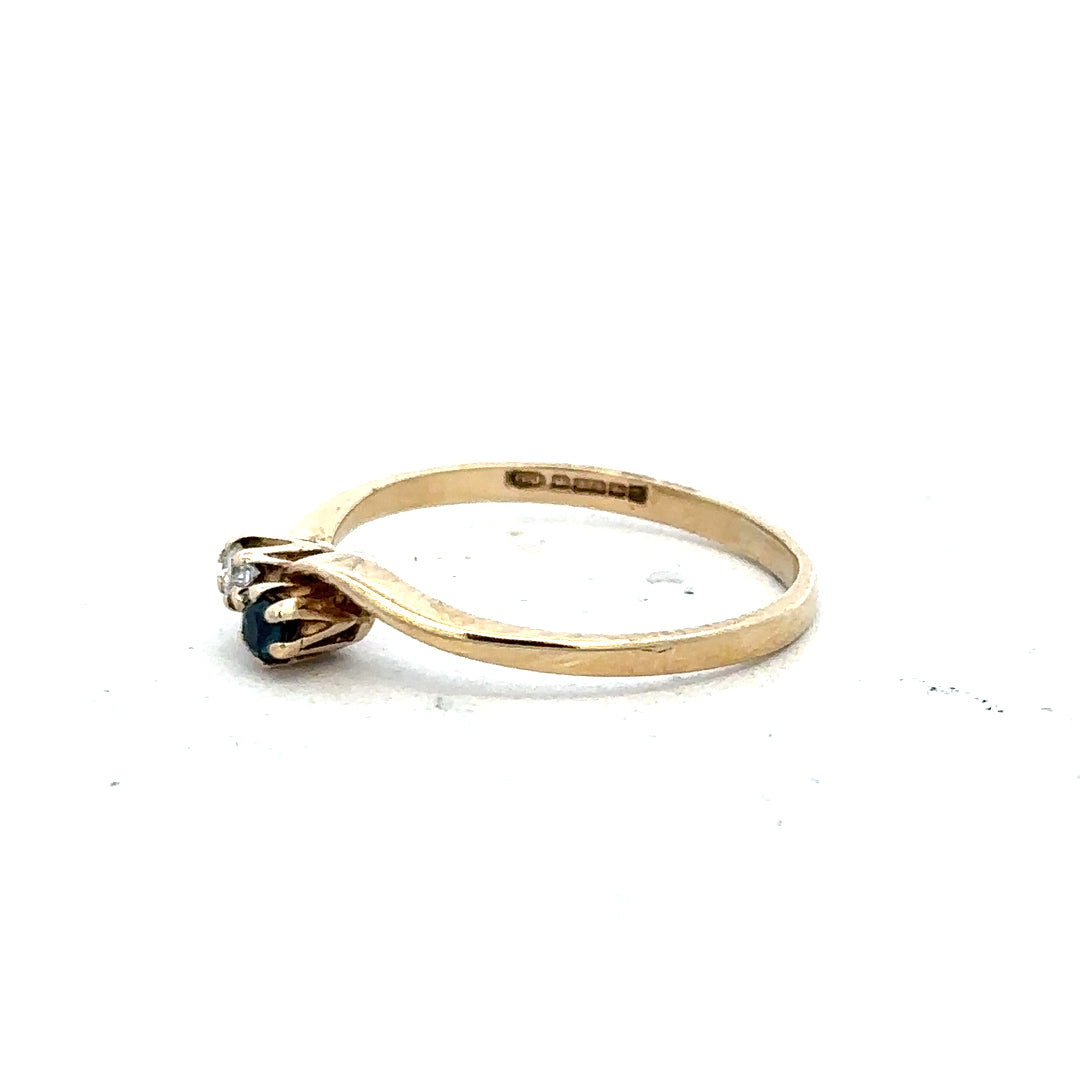 9ct yellow gold sapphire and diamond ring, size M, featuring a central sapphire with diamond accents on a sleek band.