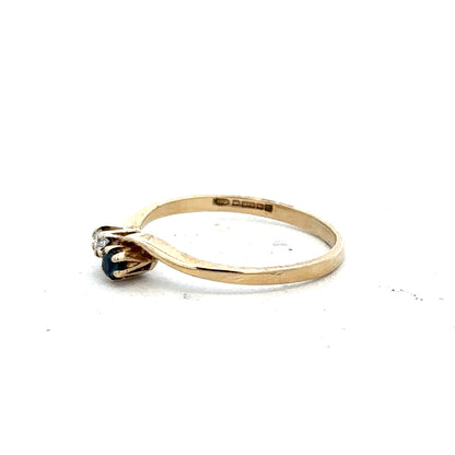 9ct yellow gold sapphire and diamond ring, size M, featuring a central sapphire with diamond accents on a sleek band.