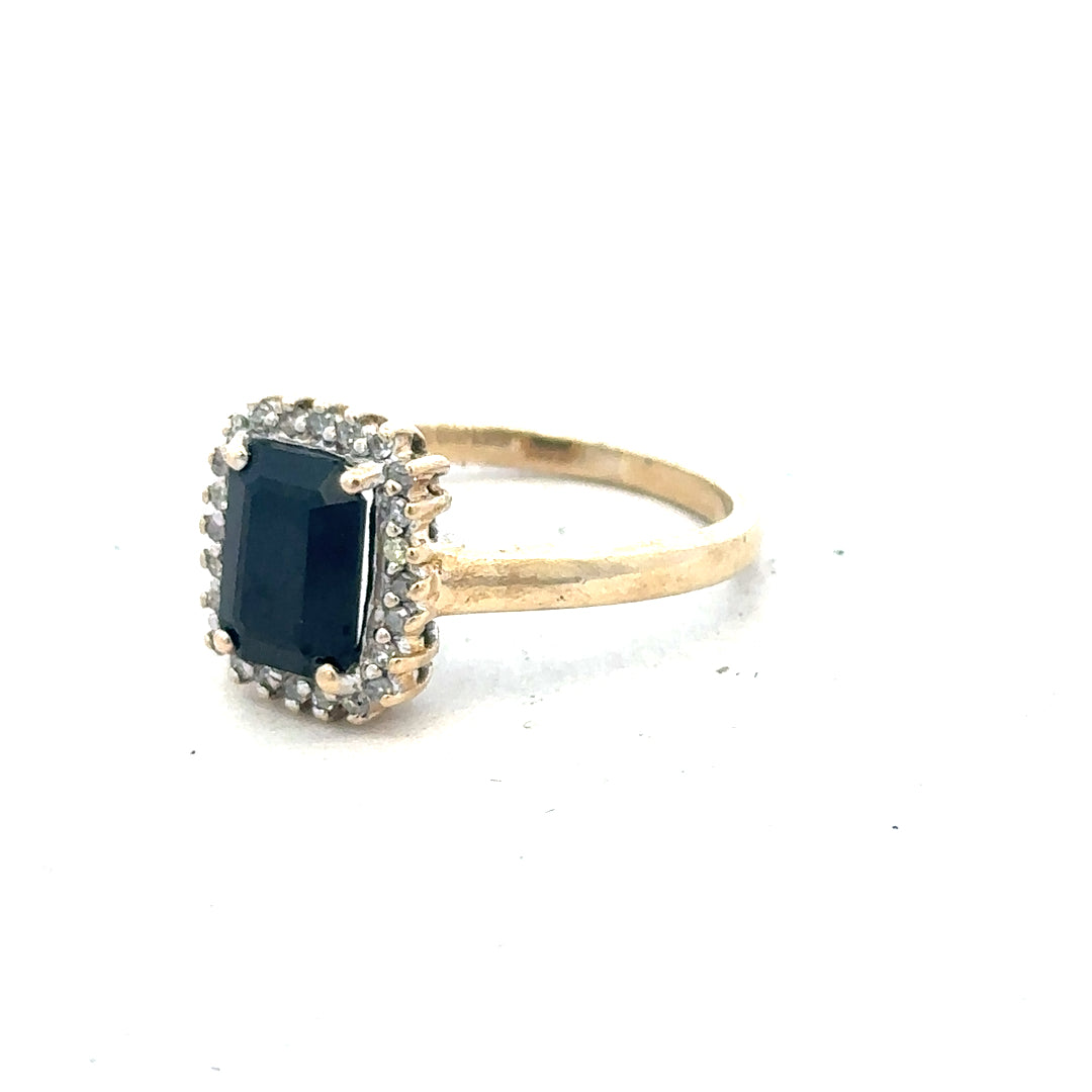 9ct yellow gold sapphire and diamond ring in size O, featuring a detailed close-up of the jewelry design.