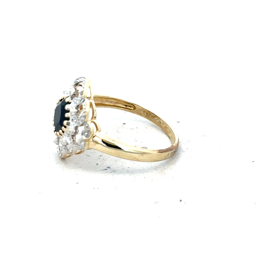 9ct yellow gold sapphire and diamond ring in size P, featuring a central blue sapphire with surrounding diamonds.