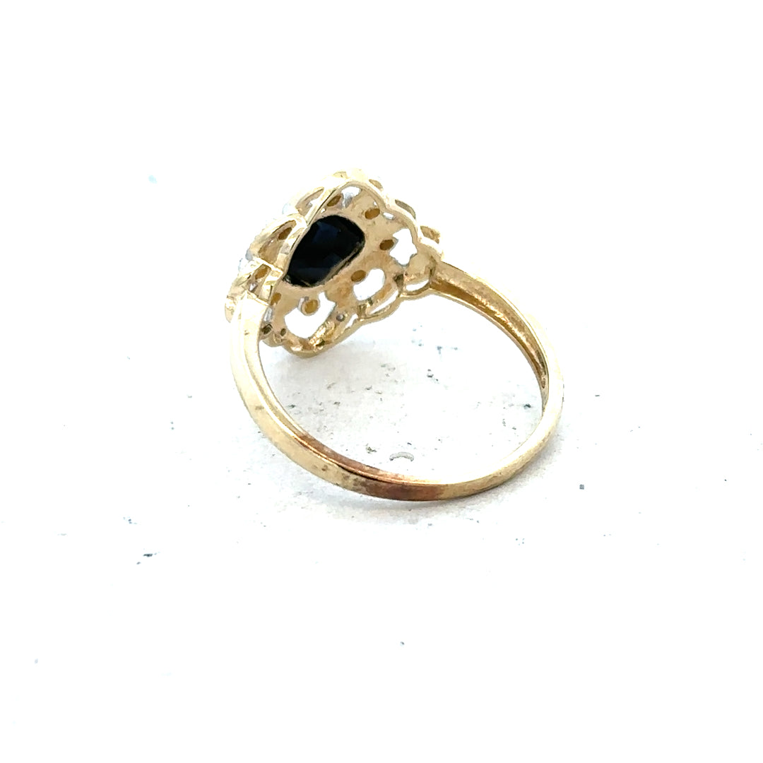 9ct yellow gold sapphire and diamond ring in size P, featuring a central sapphire with diamond accents.