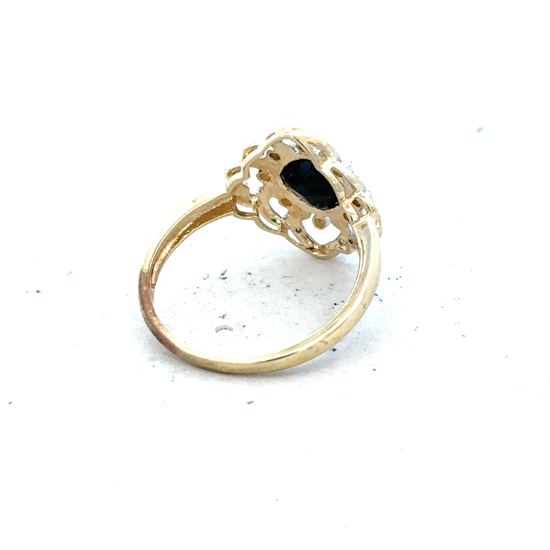 9ct yellow gold sapphire and diamond ring, size P, featuring a central sapphire gemstone with surrounding diamonds.