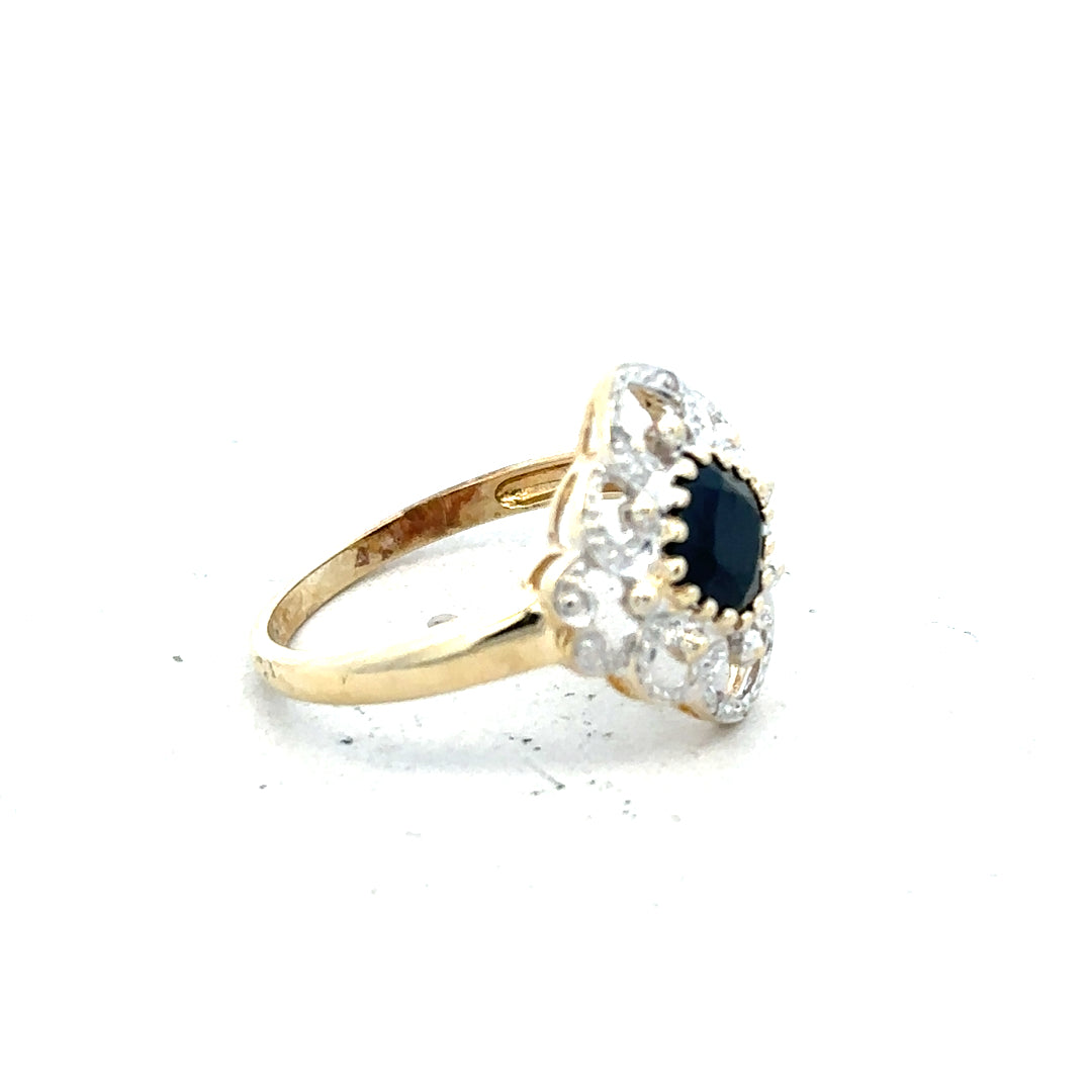 9ct yellow gold sapphire and diamond ring in size P, featuring a central sapphire with diamond accents.