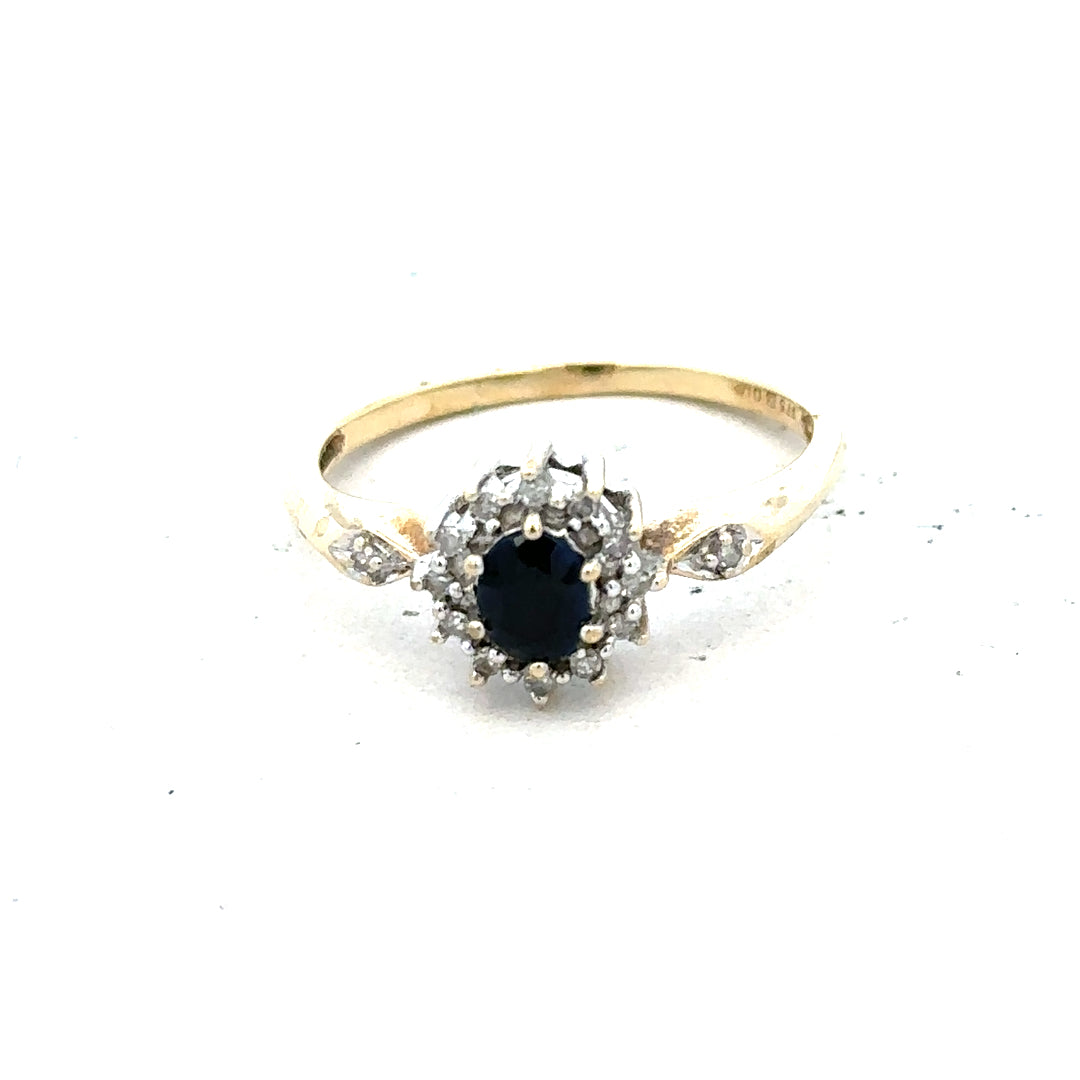 9ct yellow gold sapphire and diamond ring in size P, featuring a central sapphire surrounded by sparkling diamonds.