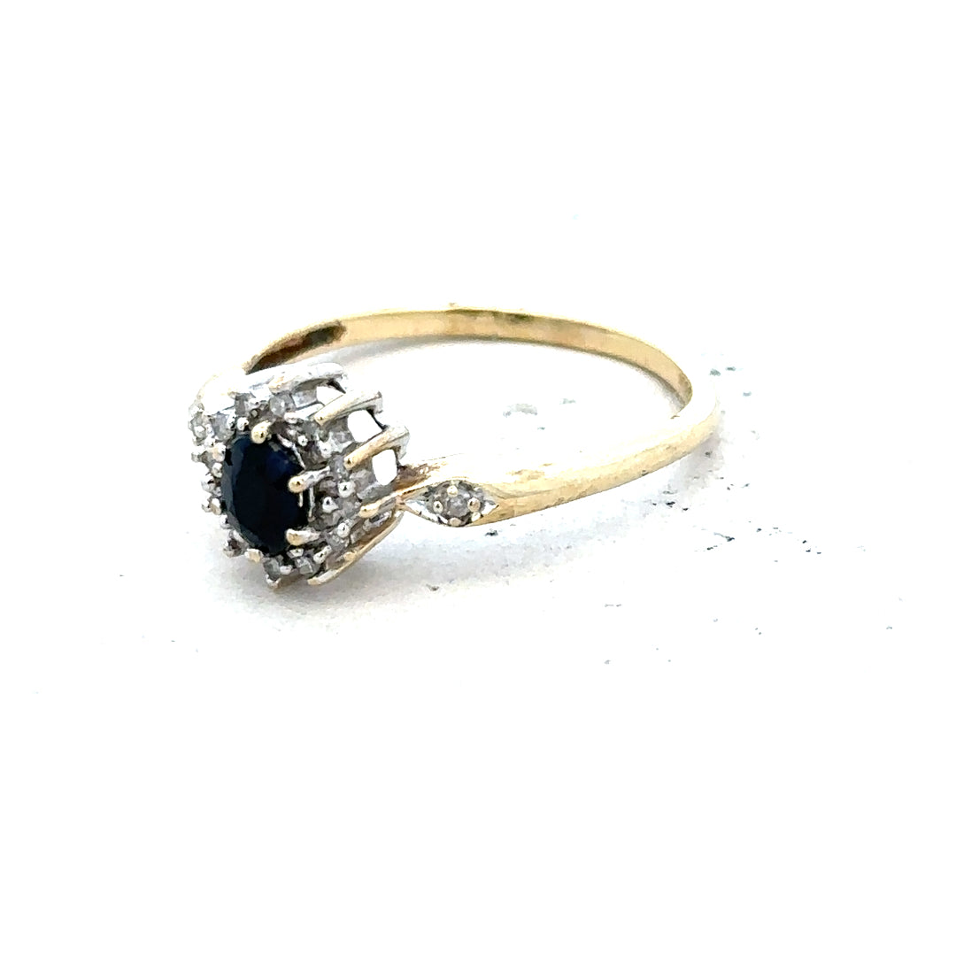 9ct yellow gold sapphire and diamond ring in size P, featuring a central sapphire gemstone and diamond accents.
