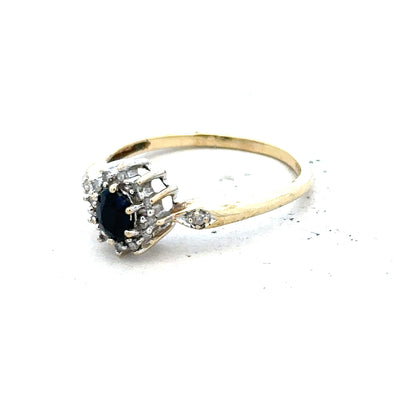 9ct yellow gold sapphire and diamond ring in size P, featuring a central sapphire gemstone and diamond accents.