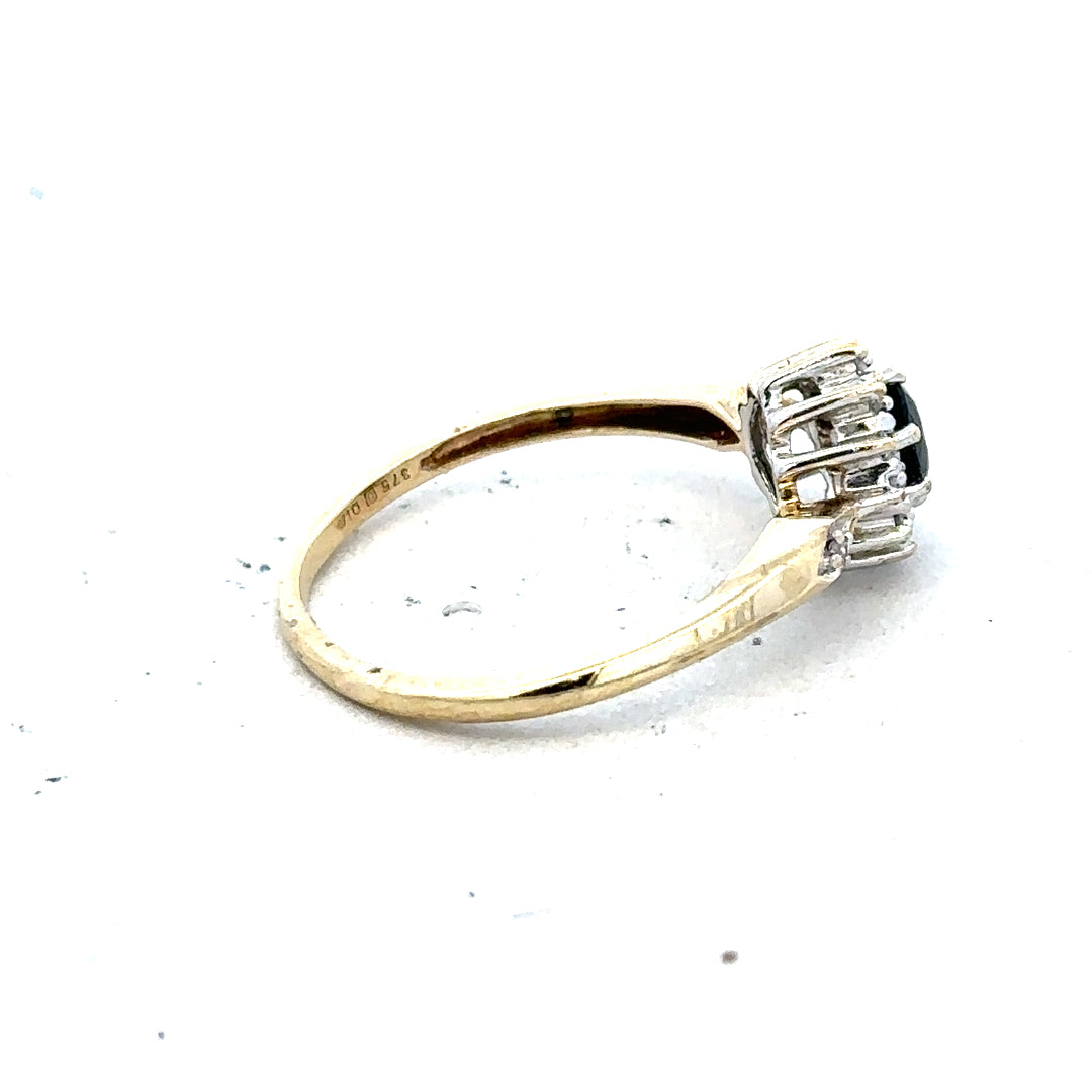 9ct yellow gold sapphire and diamond ring in size P, featuring a central sapphire with diamond accents, classic jewelry design.