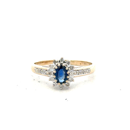 9ct yellow gold sapphire and diamond ring, size P 1/2, featuring a central sapphire with sparkling diamonds.