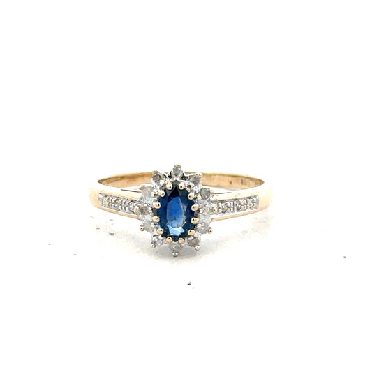9ct yellow gold sapphire and diamond ring, size P 1/2, featuring a central sapphire with sparkling diamonds.