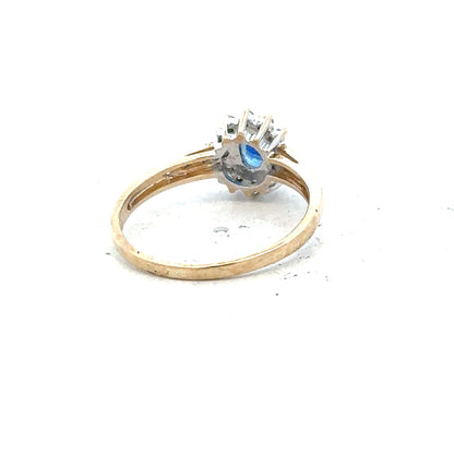9ct yellow gold sapphire and diamond ring in size P1/2, featuring a central sapphire with diamond accents.