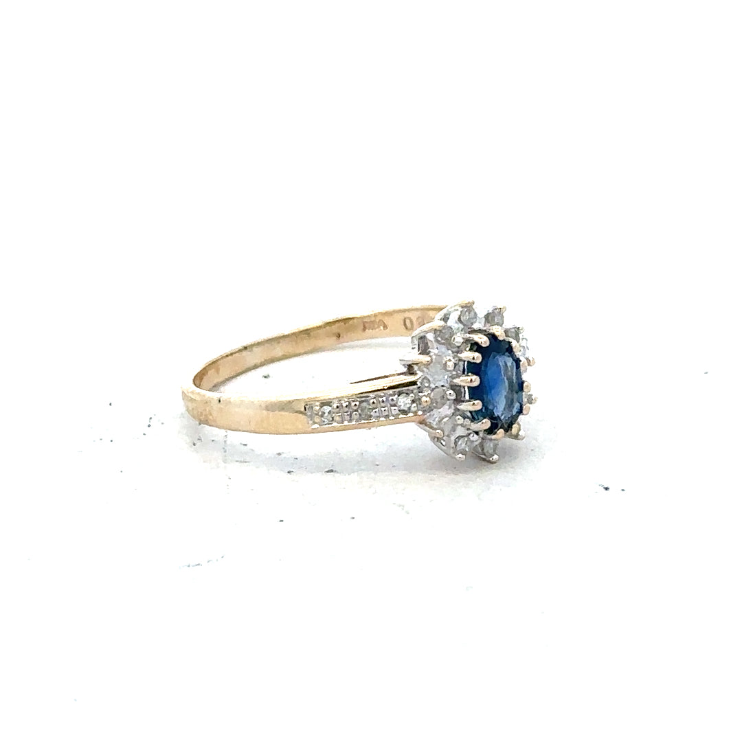 9ct yellow gold sapphire and diamond ring, size P 1/2, featuring a detailed design with vibrant blue sapphire and sparkling diamonds.