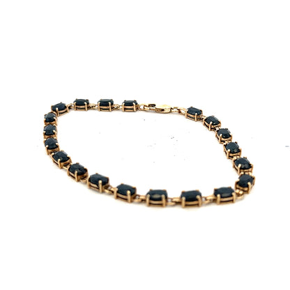 9ct yellow gold sapphire bracelet with a delicate design, showcasing blue sapphires set in elegant gold, weight 8.2g.