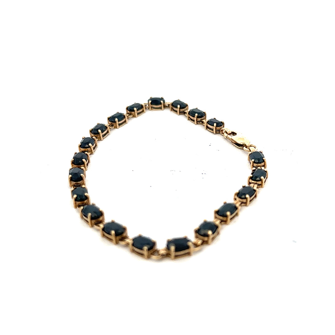 9ct yellow gold sapphire bracelet with a delicate design, featuring vibrant blue sapphires and a secure clasp.