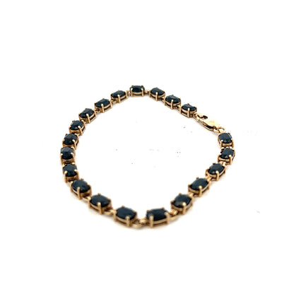 9ct yellow gold sapphire bracelet with a delicate design, featuring vibrant blue sapphires and a secure clasp.