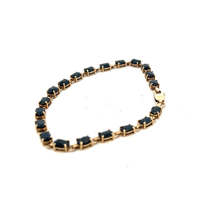9ct yellow gold sapphire bracelet with a delicate chain and sparkling blue sapphires, weighing 8.2 grams.