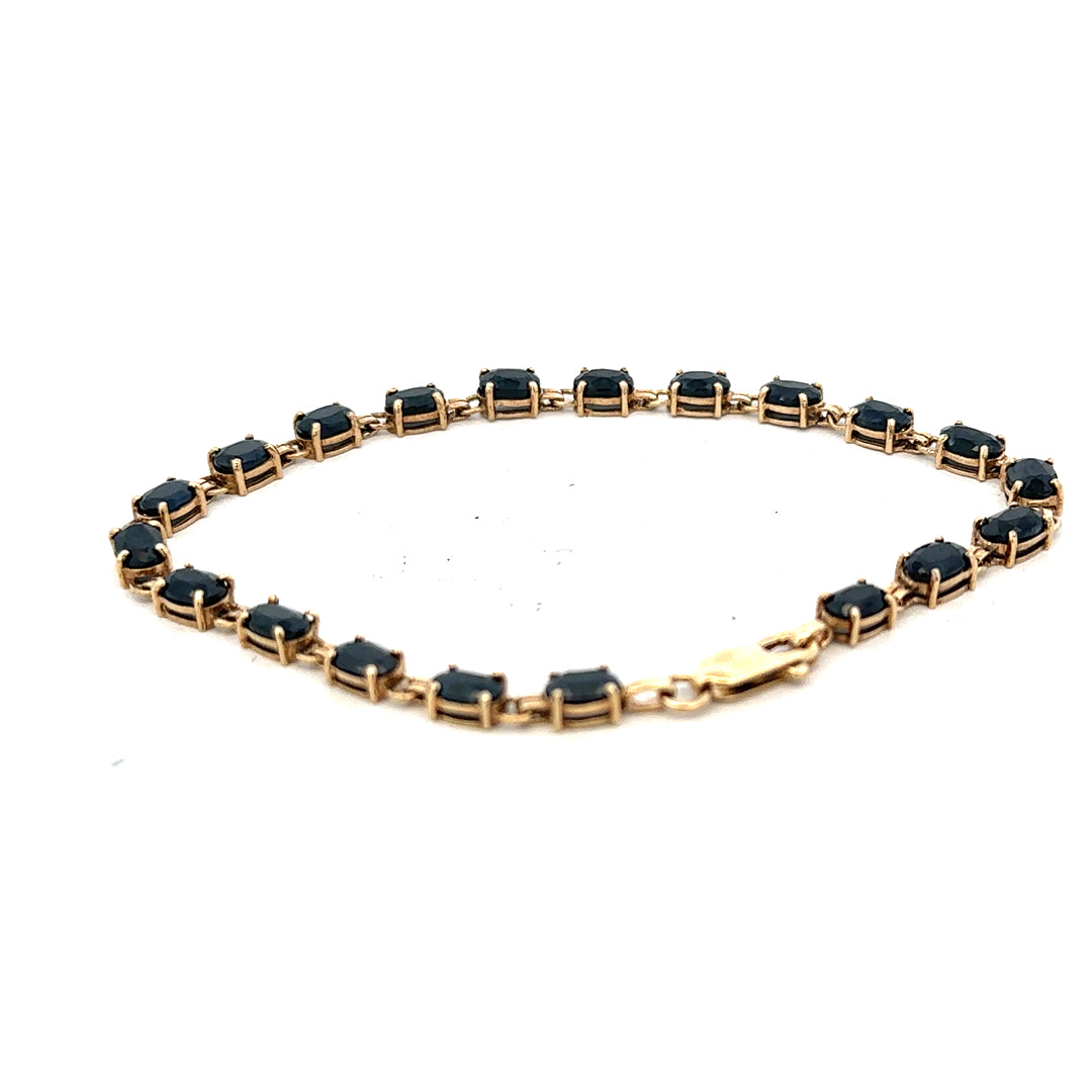 9ct yellow gold sapphire bracelet showing a delicate chain with blue sapphires, weighing 8.2g, unbranded jewelry accessory