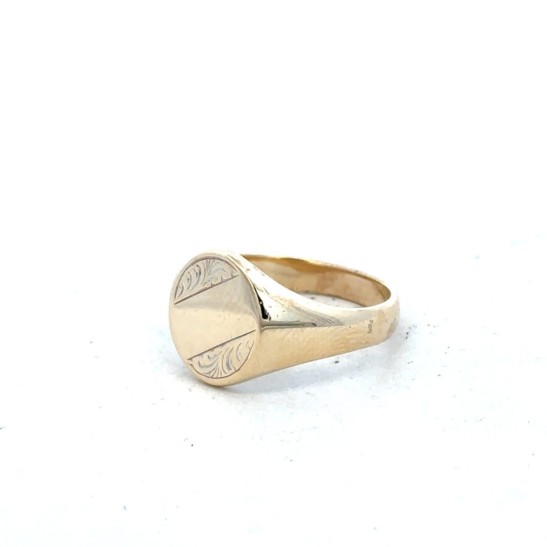 9ct yellow gold signet ring in size X1/2 displayed on a plain background, showcasing its smooth, polished surface and classic design.