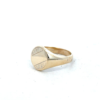 9ct yellow gold signet ring in size X1/2 displayed on a plain background, showcasing its smooth, polished surface and classic design.