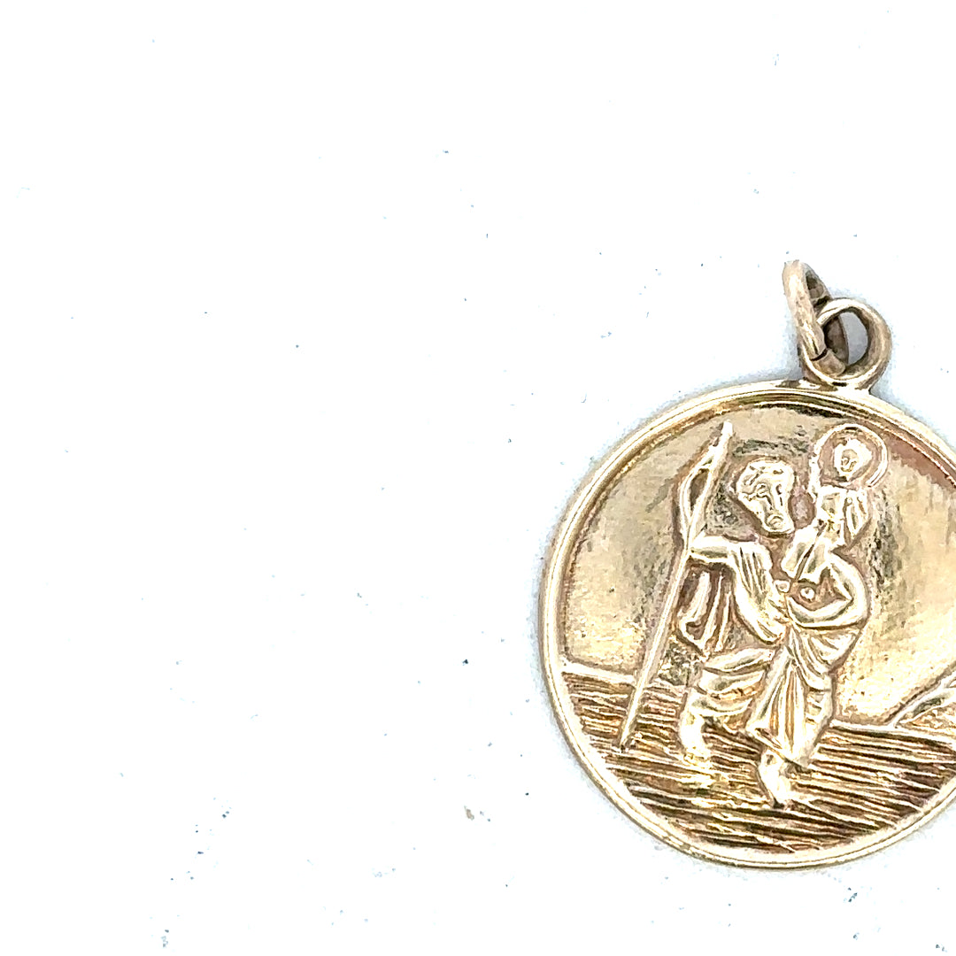 9ct yellow gold St. Christopher pendant, unbranded, weighing 5.7g, detailed religious jewelry with intricate design.
