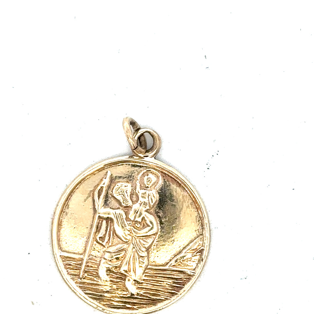 9ct yellow gold St. Christopher pendant weighing 5.7g, unbranded, with detailed religious design and chain attachment.