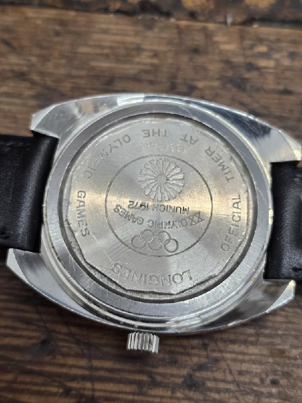Longines 1972 Munich Olympics watch with gold-tone case and sports dial, featuring Olympic logo and chronograph functions.