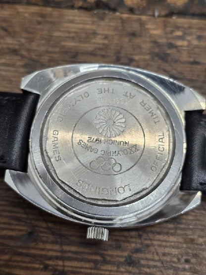 Longines 1972 Munich Olympics watch with gold-tone case and sports dial, featuring Olympic logo and chronograph functions.