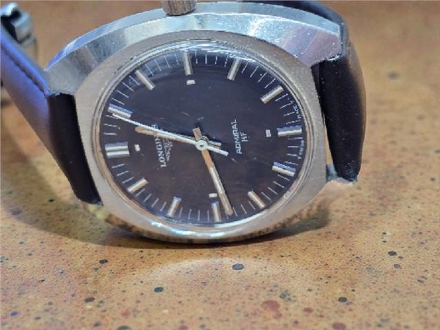 Longines 1972 Munich Olympics watch with gold-tone case and black leather strap, featuring Olympic logo on dial.