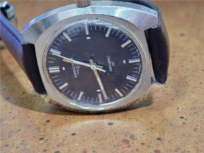 Longines 1972 Munich Olympics watch with gold-tone case and black leather strap, featuring Olympic logo on dial.