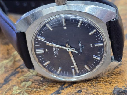 Vintage Longines 1972 Munich Olympics watch with gold-tone case and detailed dial, displayed on a white background.