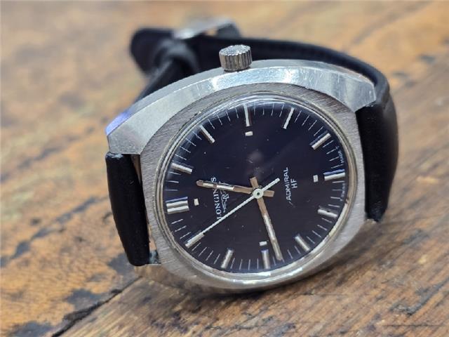 Longines 1972 Munich Olympics watch with gold-tone case and black leather strap, detailed vintage sports timepiece.