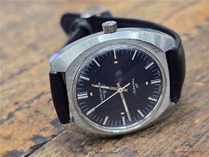 Longines 1972 Munich Olympics watch with gold-tone case and black leather strap, detailed vintage sports timepiece.