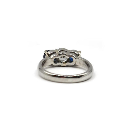 Platinum ring featuring a 1/2 carat diamond and 0.80 carat sapphire gemstone, elegant jewelry with a sleek design.
