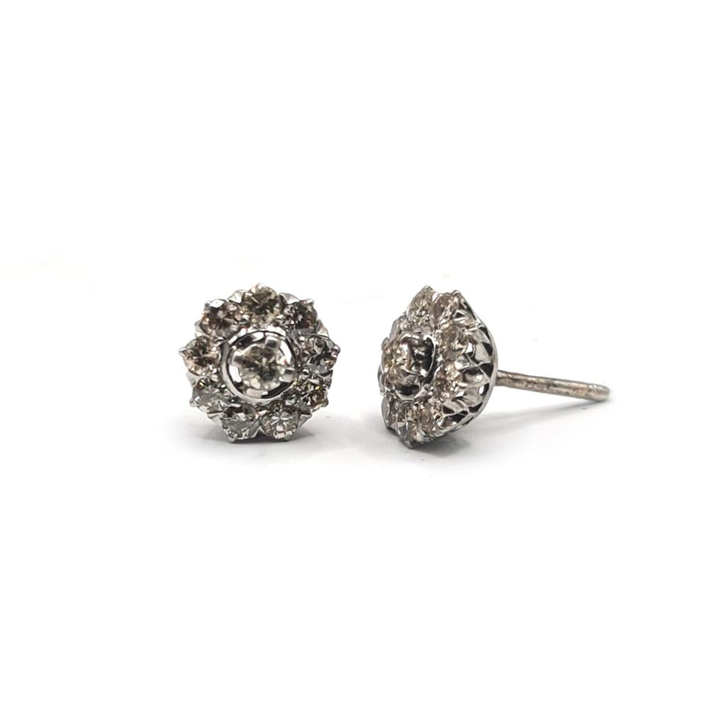 Platinum 1.40 carat diamond stud earrings featuring sparkling round cut diamonds on a sleek platinum setting.