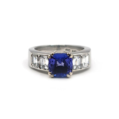 Platinum ring featuring a 1.79 carat tanzanite gemstone surrounded by 1.60 carats of sparkling diamonds.