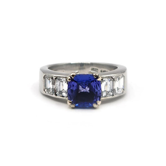 Platinum ring featuring a 1.79 carat tanzanite gemstone surrounded by 1.60 carats of sparkling diamonds.