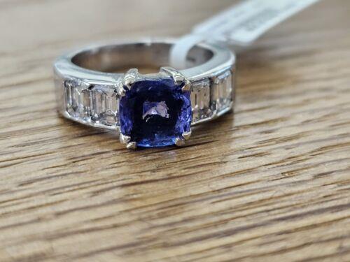 Platinum ring featuring a 1.79 carat tanzanite gemstone surrounded by 1.60 carat diamonds. Elegant jewelry design.