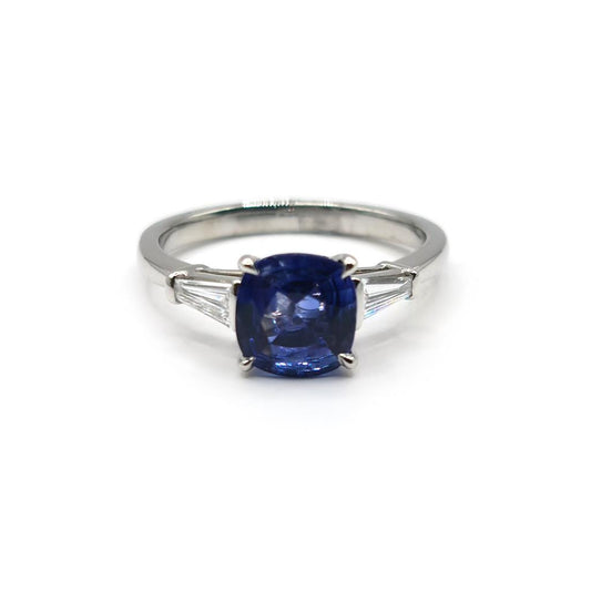 Platinum ring with a 1.85 carat blue sapphire and 0.20 carat diamonds, elegant jewelry featuring a polished band and gemstone accents.